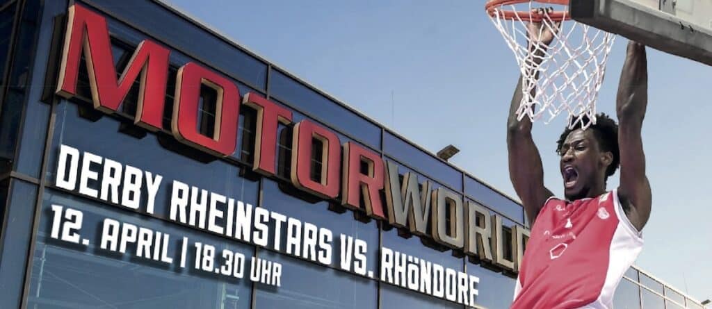 Außenfassade der Mondorworld-Halle mit Ankündigung: Derby RheinStars vs. Rhöndorf am 12. April 18:30 Uhr, Basketballspieler beim Dunking.